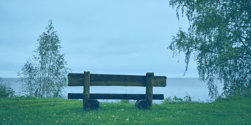 What to expect from our podcast editing services blog: a peaceful bench next to a body of water to support the text that says we do not work on Saturdays and Sundays.